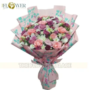 Vibrant mixed bouquet of red roses and pink chrysanthemums with stylish wrapping for delivery in Islamabad.
